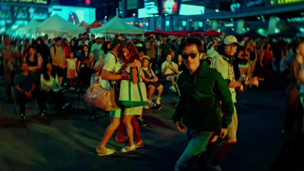 Festival-goers dance in the square after dark