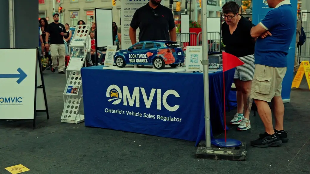 OMVIC staff speak with visitors at their WorldFest booth
