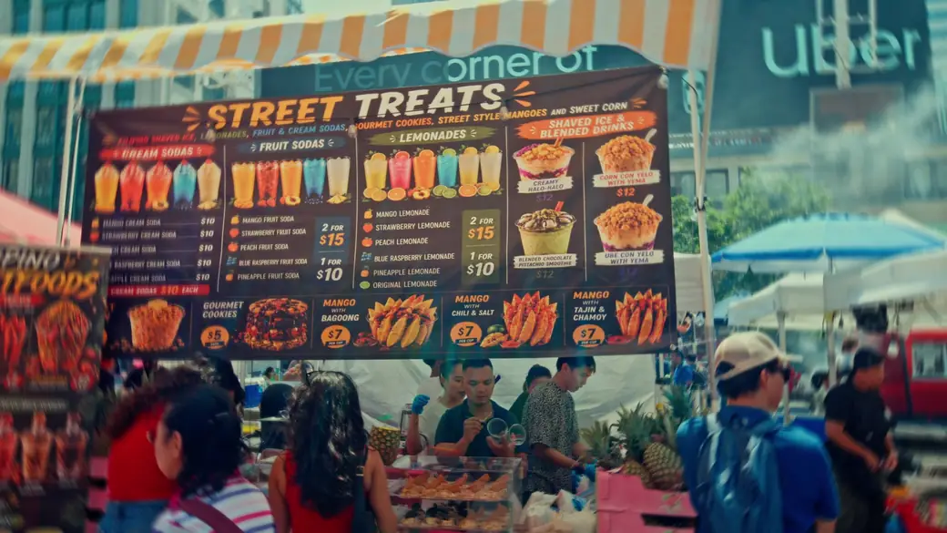 A Street Treats menu board above a busy food stall