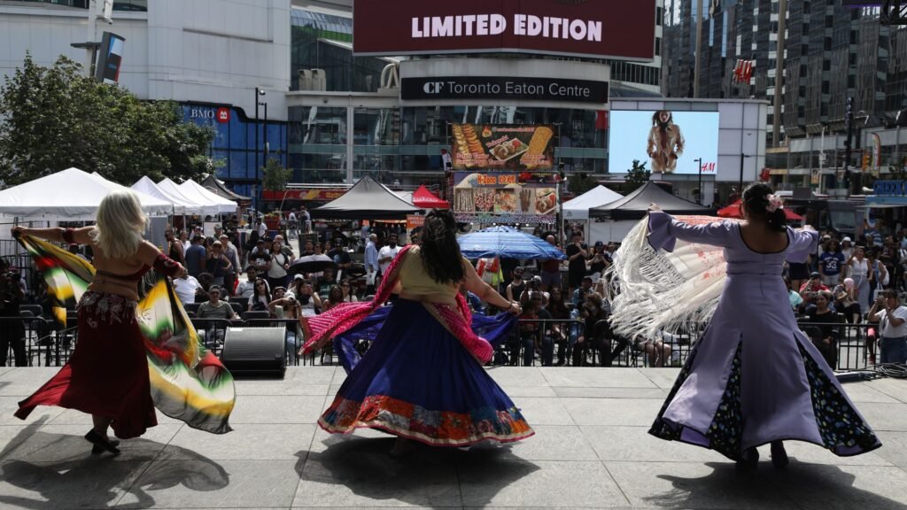 Live fusion cultural performances at WorldFest Canada 2026 featuring diverse dance traditions on a central city stage
