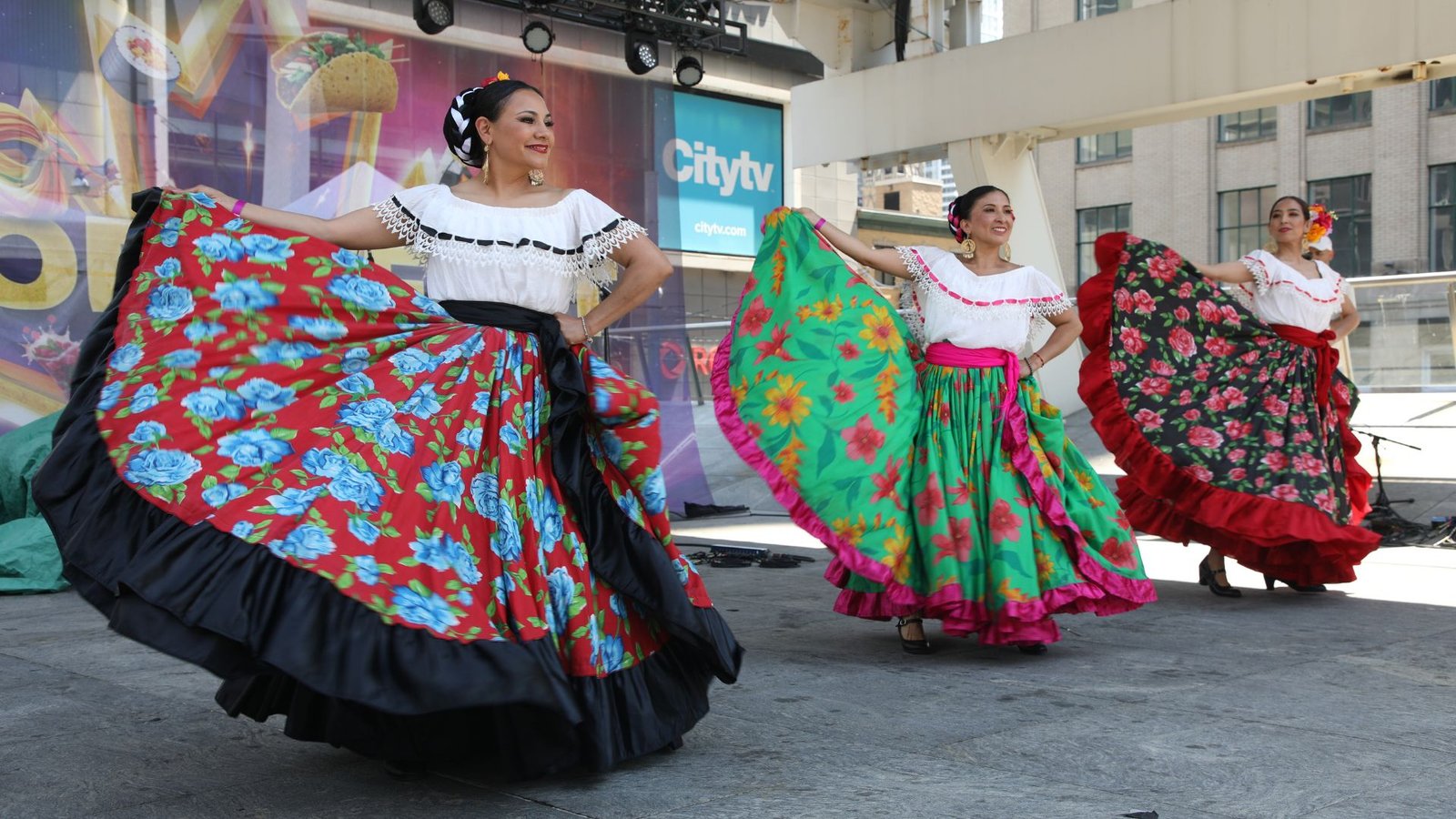 Toronto summer festival crowd enjoying food and live cultural performances.