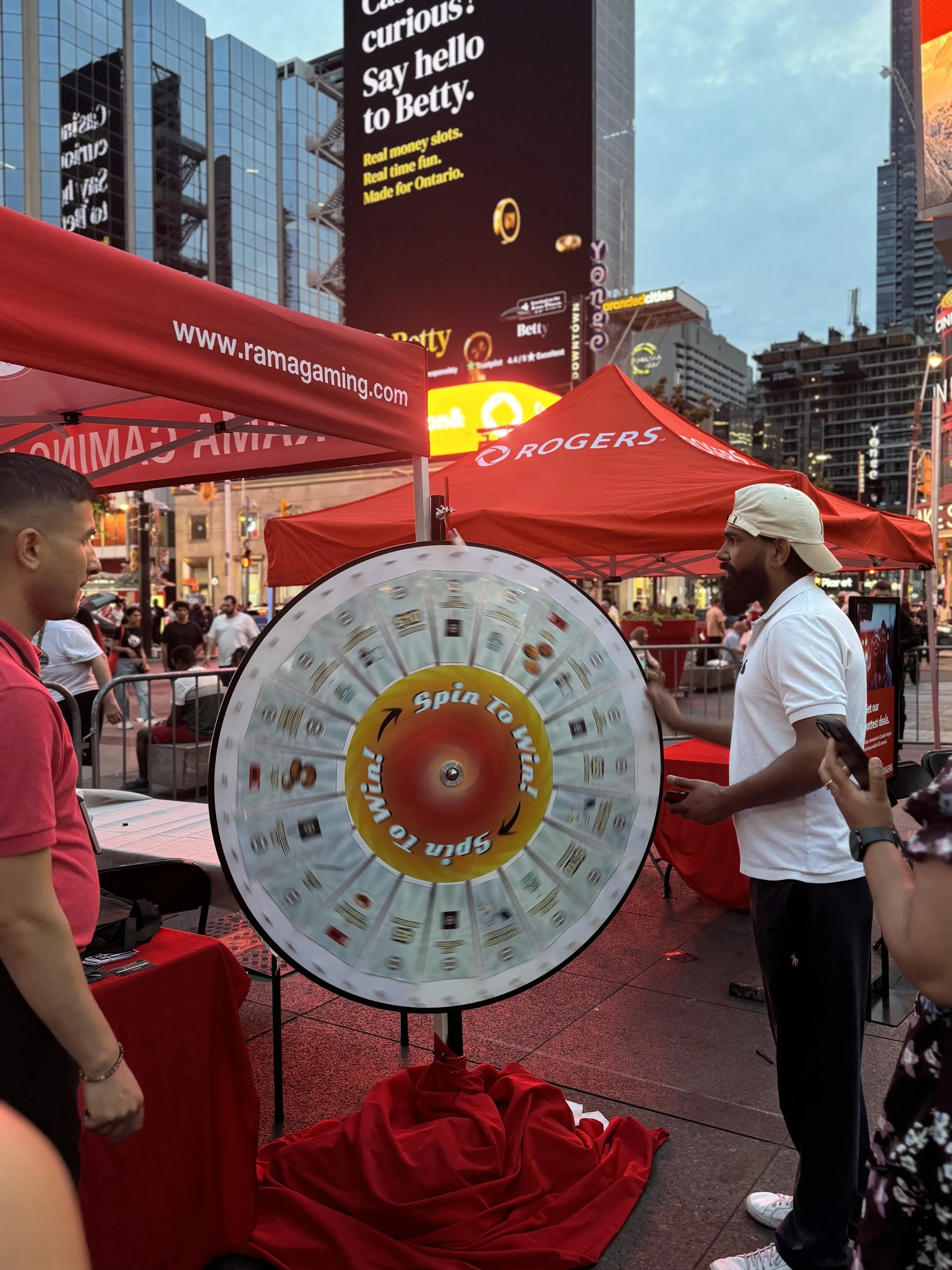 The Rogers tent on Sankofa Square during WorldFest, with festival-goers at the prize wheel